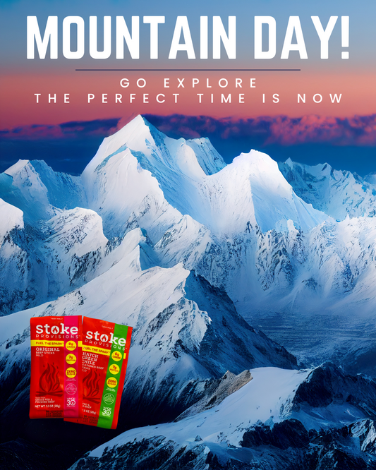 A diverse group of individuals enjoys an outdoor adventure, gathered around a campfire sharing grass-fed beef snack sticks in a lush, eco-friendly setting.