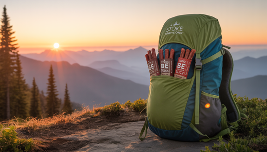 A sunrise over mountains with a backpack containing beef snack sticks from Stoke Provisions, symbolizing adventure and sustainability.